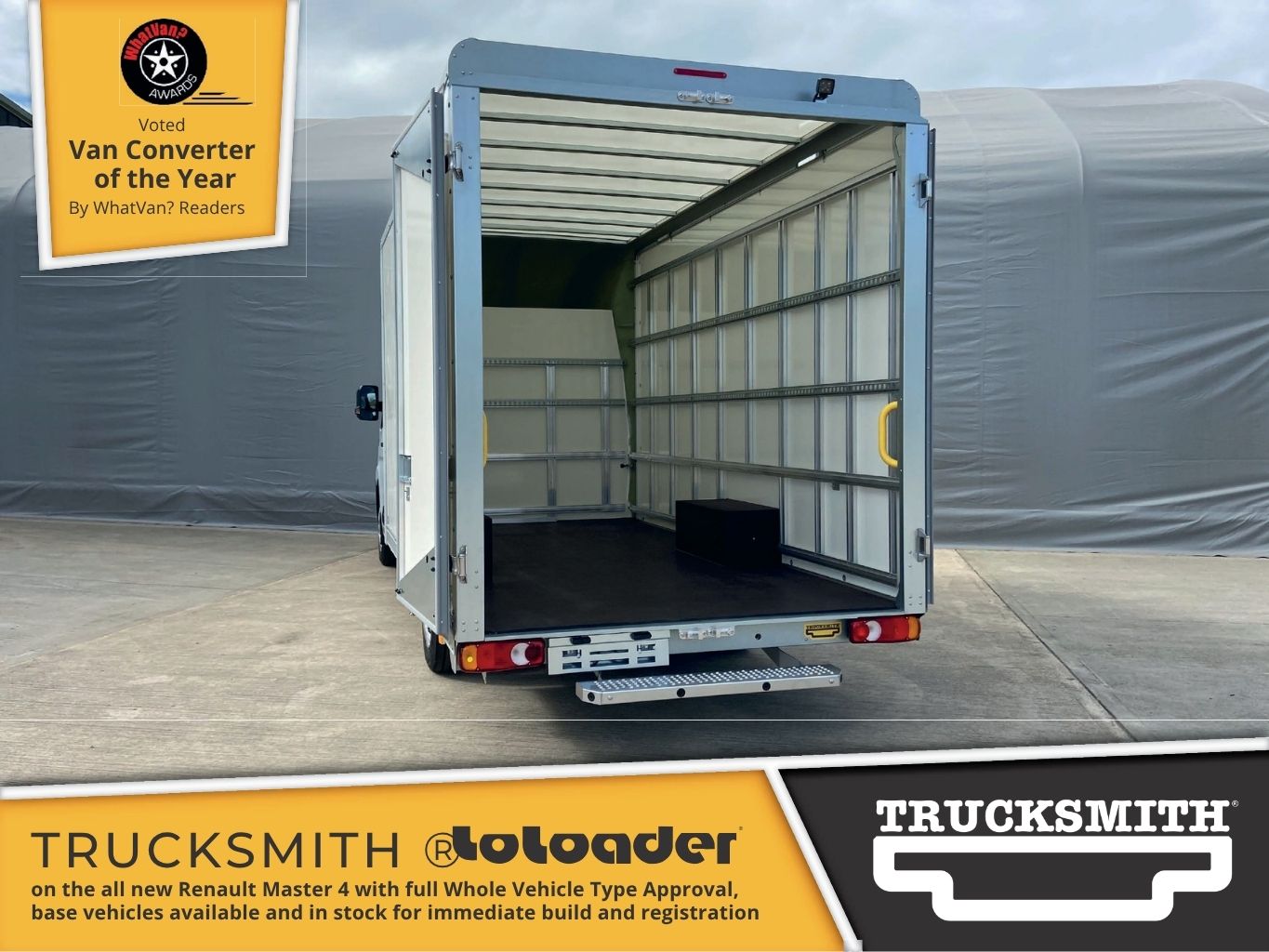 Query successful A rear view of a white Trucksmith LoLoader on the new Renault Master 4 platform cab with its rear doors open, revealing a spacious, empty cargo area. The low loading height is evident, with a small step leading into the van. The interior of the box body shows ribbed white walls, multiple horizontal cargo securing rails, and yellow grab handles. A black box is visible on the floor near the front of the cargo area. The image also displays a "Voted Van Converter of the Year" award graphic and text stating "TRUCKSMITH LoLoader on the all new Renault Master 4 with full Whole Vehicle Type Approval, base vehicles available and in stock for immediate build and registration".